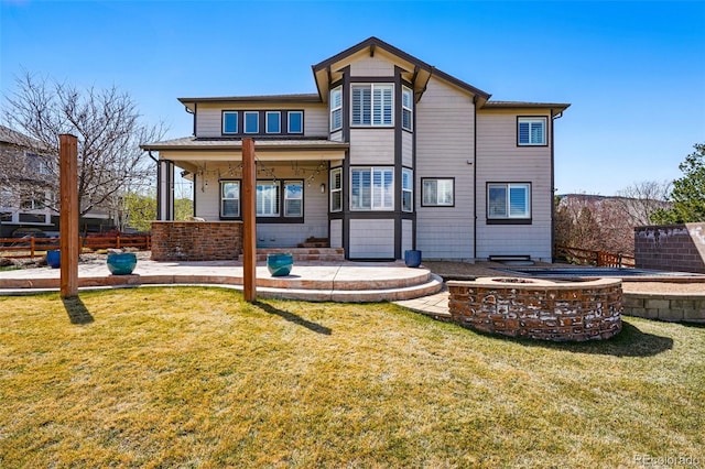 19423 W 52nd Dr, Golden, CO 80403 - back of property with a fire pit, fence, a yard, and a patio area