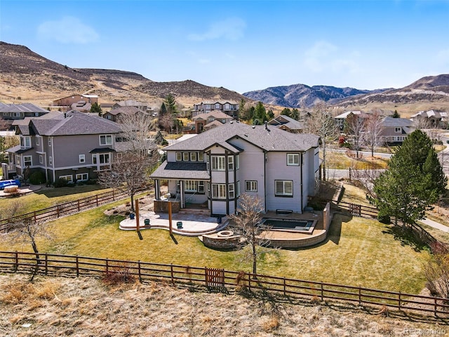 19423 W 52nd Dr, Golden, CO 80403 - back of house featuring a lawn, a mountain view, a fenced backyard, and a patio area