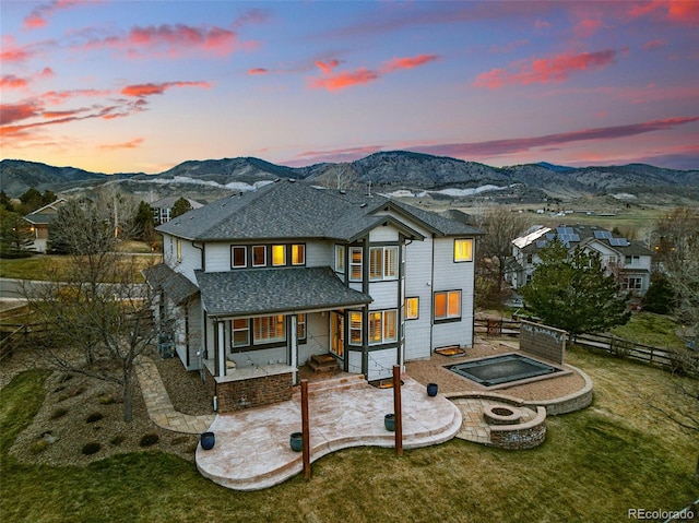19423 W 52nd Dr, Golden, CO 80403 - rear view of property with fence, an outdoor fire pit, a mountain view, a shingled roof, and a patio area