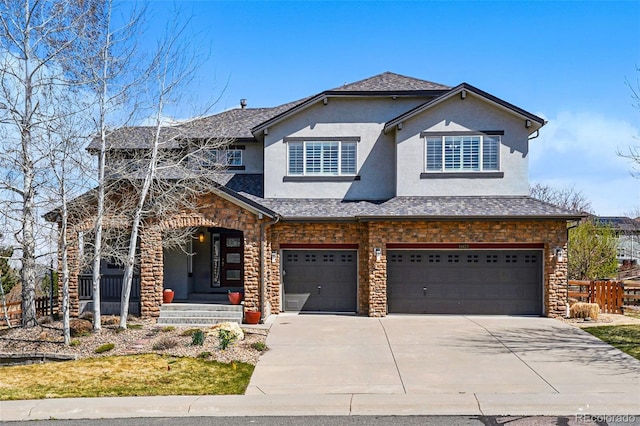 19423 W 52nd Dr, Golden, CO 80403 - view of front of property featuring stone siding, an attached garage, stucco siding, driveway, and a shingled roof
