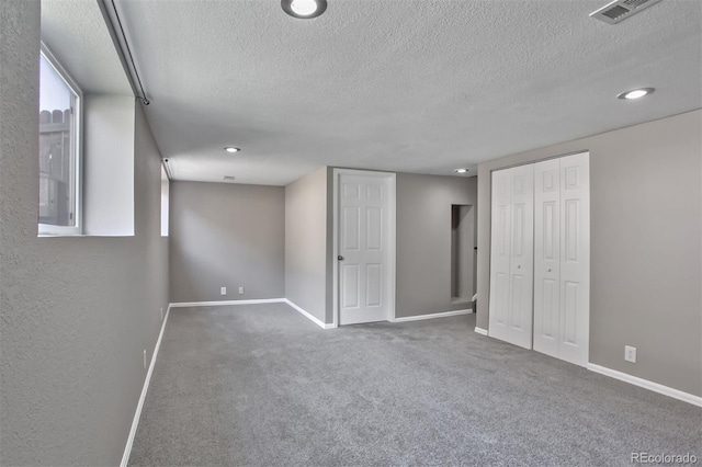 245 Homestead Way, Brighton, CO 80601 - unfurnished bedroom with a textured ceiling, carpet flooring, recessed lighting, and a closet