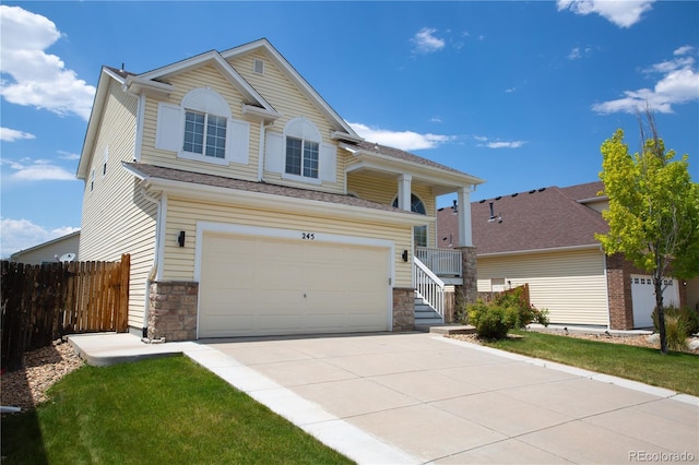 245 Homestead Way, Brighton, CO 80601 - view of front facade with a garage, concrete driveway, and stone siding