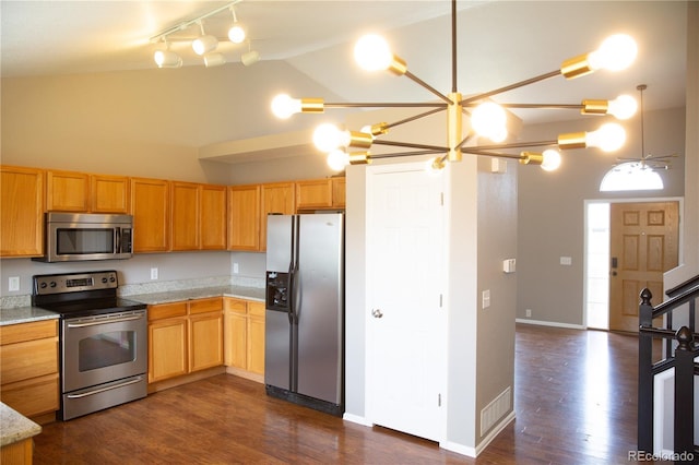 245 Homestead Way, Brighton, CO 80601 - kitchen with stainless steel appliances, light countertops, track lighting, dark wood-style floors, and high vaulted ceiling