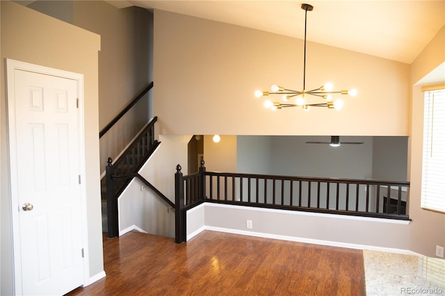 245 Homestead Way, Brighton, CO 80601 - unfurnished room with wood finished floors, lofted ceiling, and a chandelier