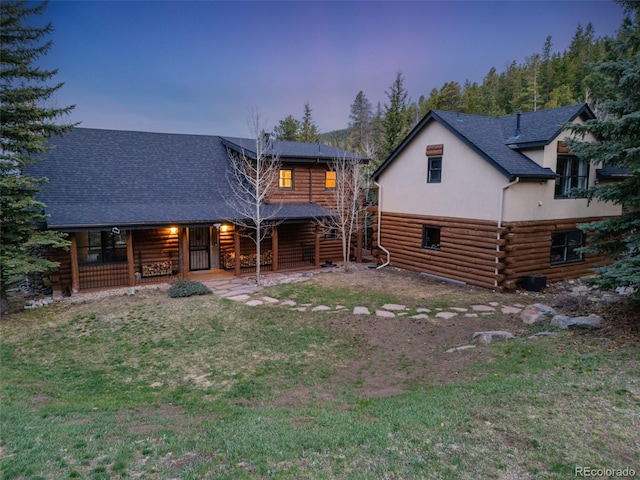 24 Pine Valley Rd, Evergreen, CO 80439 - back of property featuring a porch, a shingled roof, a lawn, and log siding
