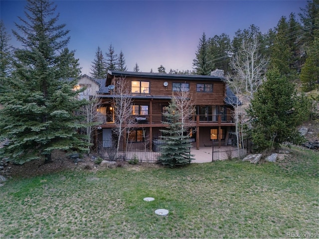 24 Pine Valley Rd, Evergreen, CO 80439 - back of house with a lawn, a patio area, and a chimney