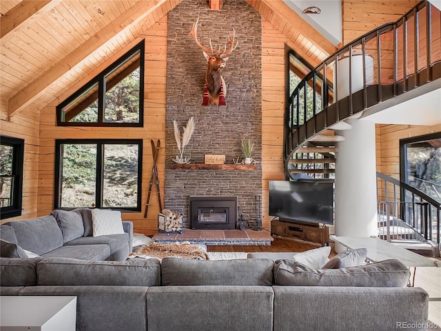 24 Pine Valley Rd, Evergreen, CO 80439 - living area with wood walls, high vaulted ceiling, and stairway