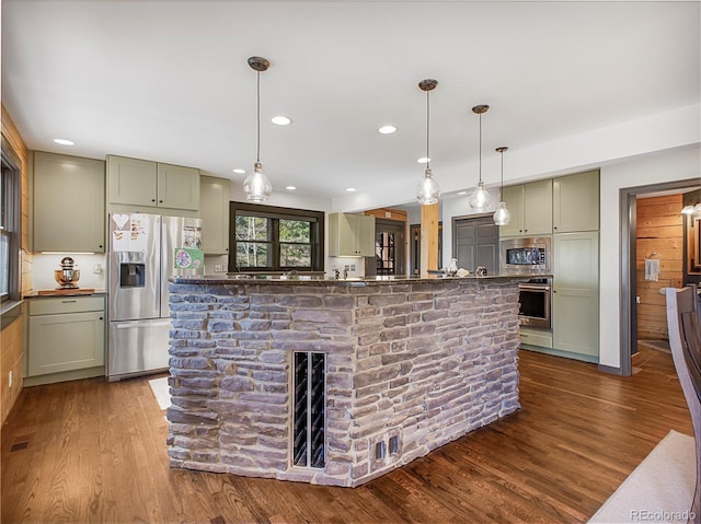 24 Pine Valley Rd, Evergreen, CO 80439 - kitchen with dark wood finished floors, decorative light fixtures, and stainless steel appliances