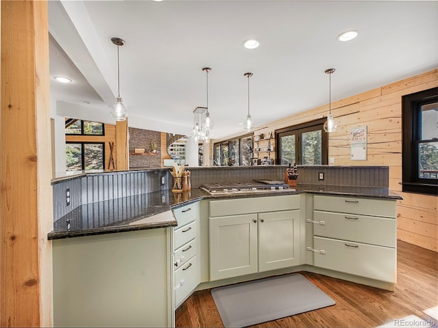 24 Pine Valley Rd, Evergreen, CO 80439 - kitchen featuring dark stone counters, a healthy amount of sunlight, hanging light fixtures, and stainless steel gas stovetop