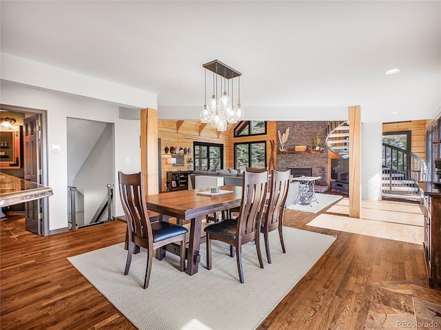 24 Pine Valley Rd, Evergreen, CO 80439 - dining space with a large fireplace, baseboards, dark wood finished floors, and stairs