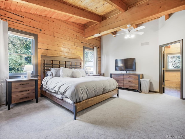 24 Pine Valley Rd, Evergreen, CO 80439 - bedroom with wooden walls, beamed ceiling, carpet flooring, and visible vents