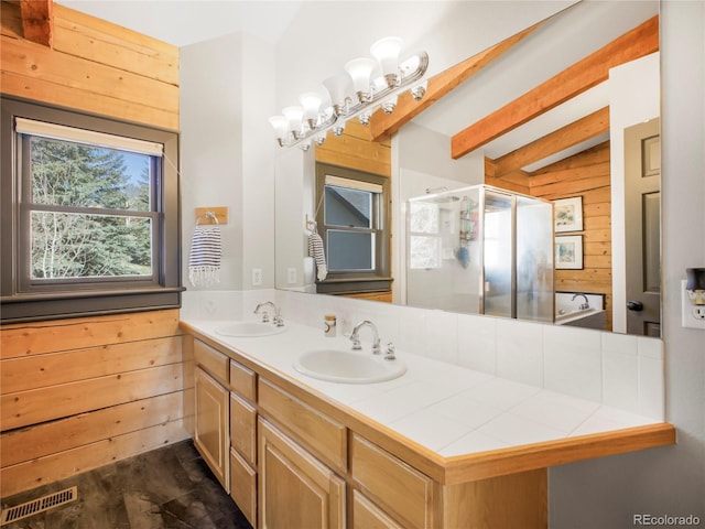 24 Pine Valley Rd, Evergreen, CO 80439 - bathroom featuring wooden walls, beamed ceiling, a shower stall, and a sink