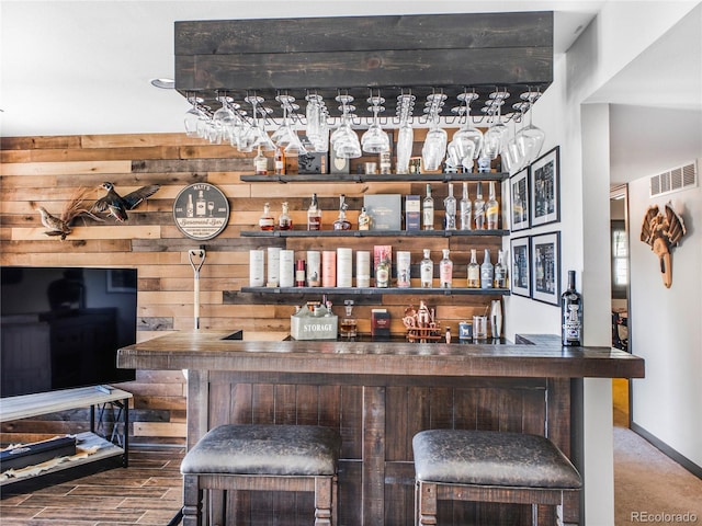 24 Pine Valley Rd, Evergreen, CO 80439 - bar with wooden walls, bar, baseboards, and visible vents