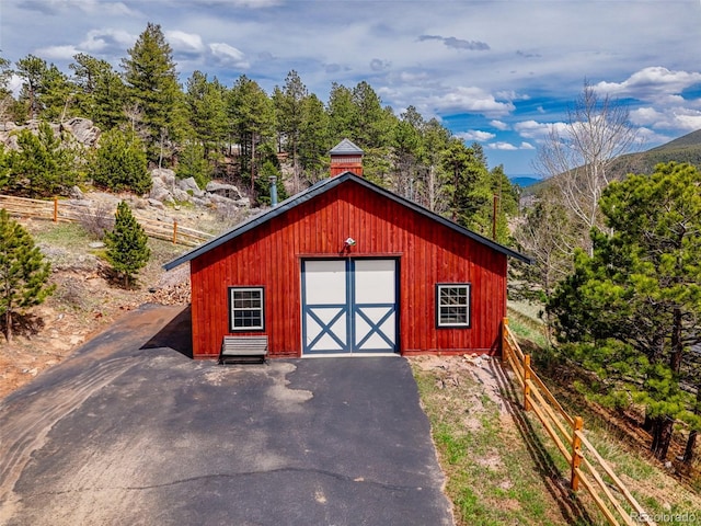 24 Pine Valley Rd, Evergreen, CO 80439 - view of outbuilding with fence, a mountain view, and an outdoor structure