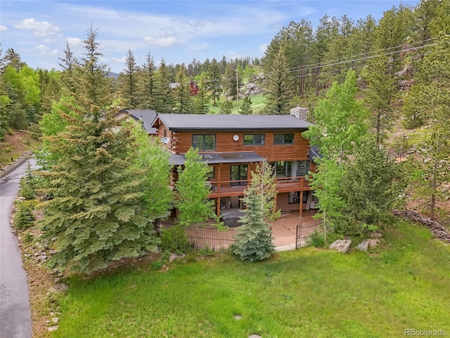 24 Pine Valley Rd, Evergreen, CO 80439 - rear view of house featuring a view of trees, a wooden deck, a patio, and log exterior