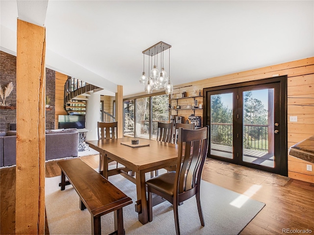 24 Pine Valley Rd, Evergreen, CO 80439 - dining area featuring wood walls, wood finished floors, and french doors