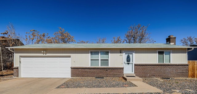 ranch-style home with an attached garage, brick siding, driveway, and a chimney