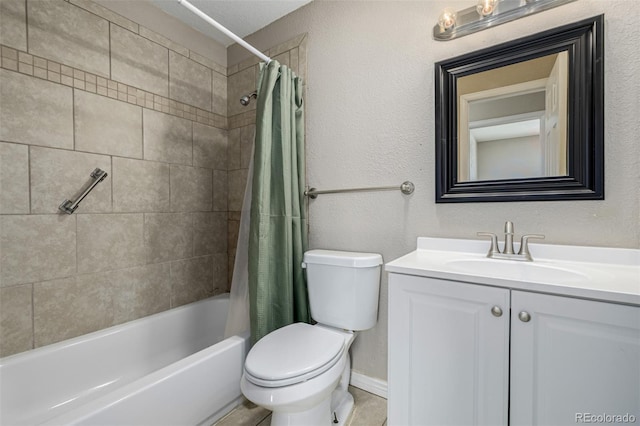 bathroom featuring toilet, vanity, a textured wall, and shower / bath combo