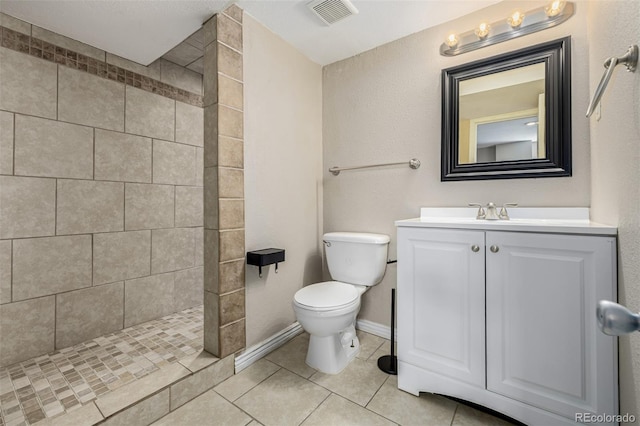 full bathroom with vanity, visible vents, tiled shower, tile patterned flooring, and toilet