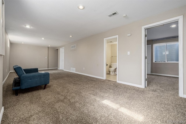 living area with recessed lighting, visible vents, baseboards, and carpet