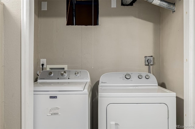 clothes washing area featuring washer and dryer and laundry area