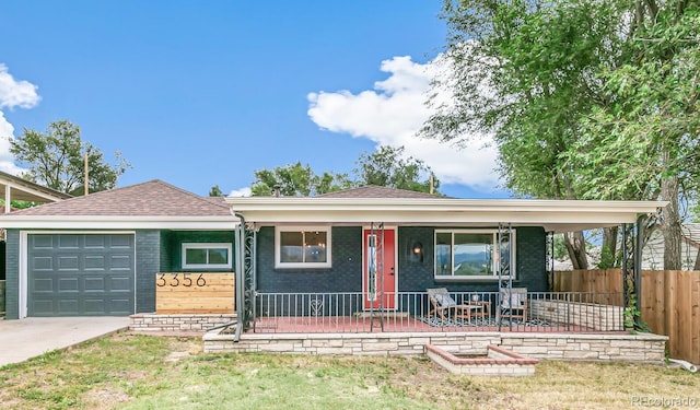 single story home featuring a garage, covered porch, and a front lawn