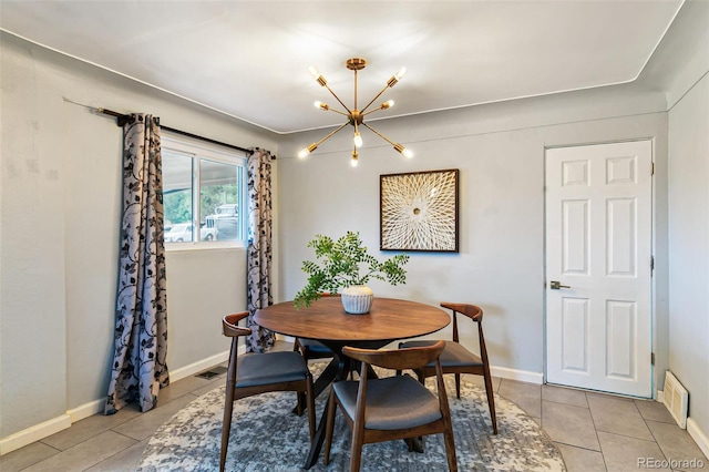 tiled dining room with an inviting chandelier