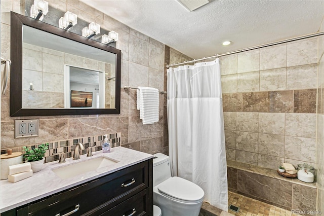 bathroom featuring tile walls, vanity, a textured ceiling, decorative backsplash, and walk in shower