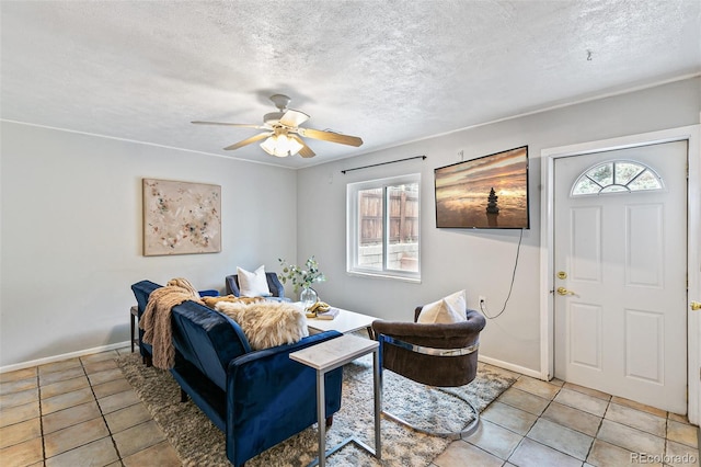 tiled living room featuring a textured ceiling and ceiling fan