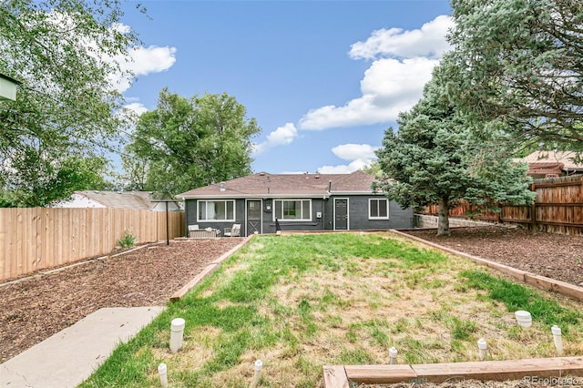 rear view of house with a lawn