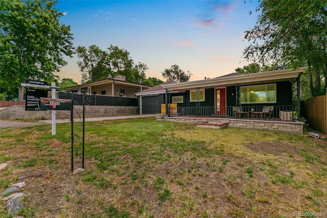 ranch-style house featuring a garage and a lawn