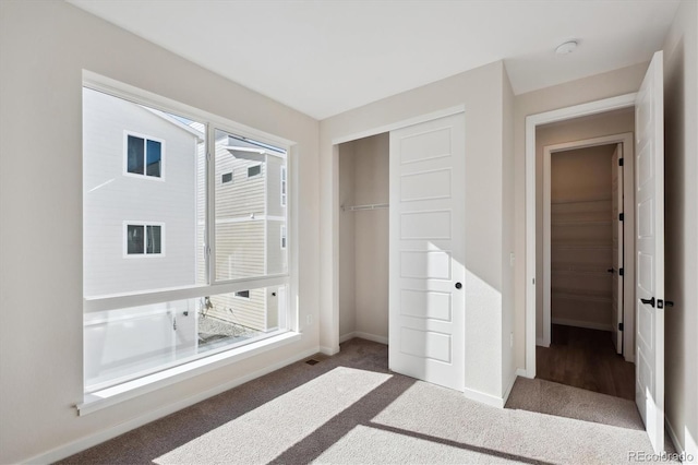 unfurnished bedroom with carpet and a closet