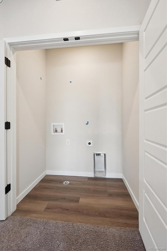 laundry room featuring dark wood-type flooring, hookup for an electric dryer, and hookup for a washing machine