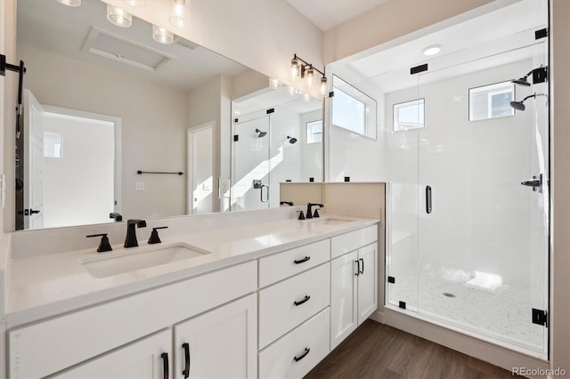 bathroom with vanity, hardwood / wood-style floors, and walk in shower