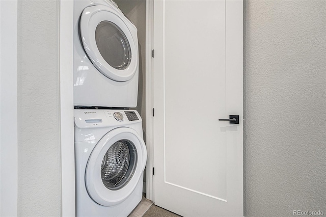 5018 S Prince Pl, Littleton, CO 80123 - laundry room featuring estacked washer and dryer and a textured wall