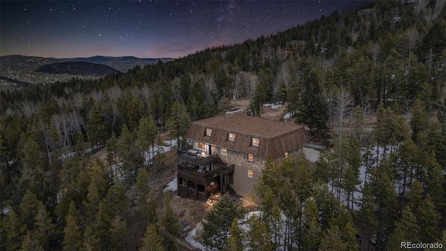 8451 London Ln, Conifer, CO 80433 - aerial view of property and surrounding area featuring a forest and a mountainous background