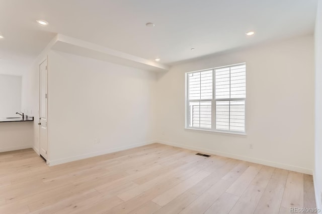 spare room with light hardwood / wood-style flooring