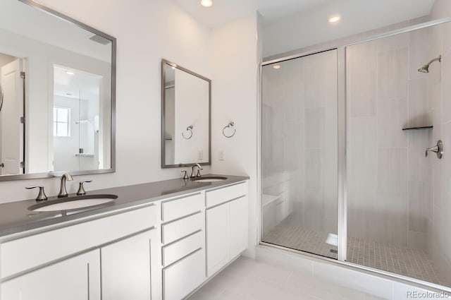 bathroom with tile patterned flooring, vanity, and an enclosed shower