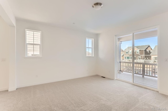 carpeted empty room featuring a healthy amount of sunlight