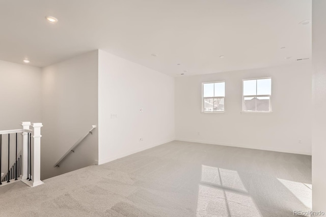 empty room featuring light carpet