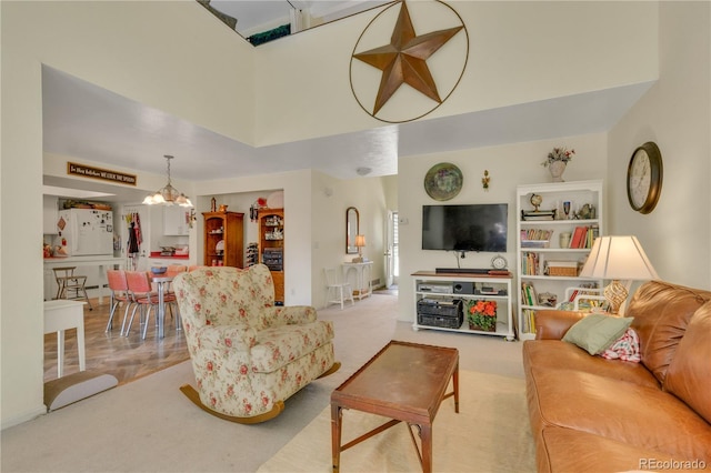 living room featuring carpet, a towering ceiling, and an inviting chandelier