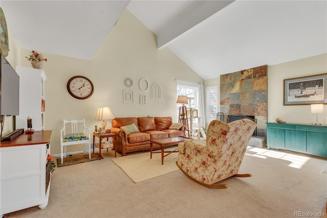 carpeted living room with a tiled fireplace, high vaulted ceiling, and beamed ceiling