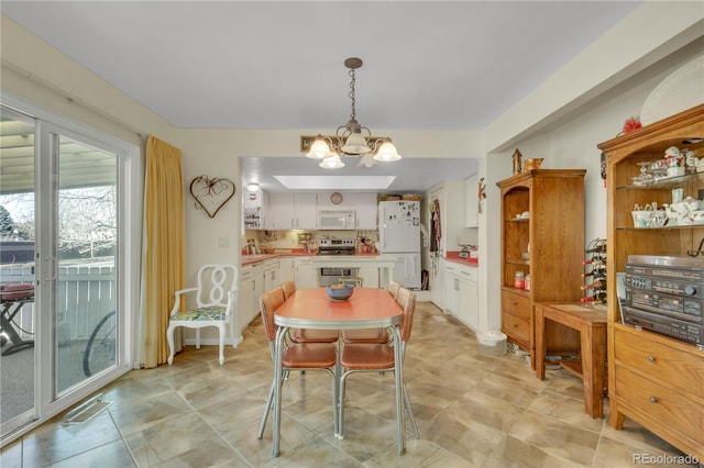 dining space featuring a chandelier and sink