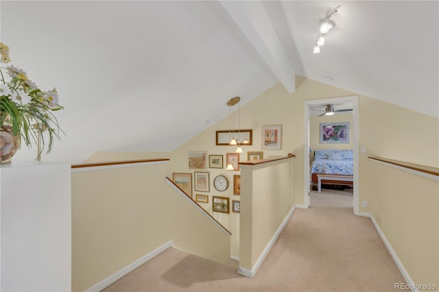 hallway featuring lofted ceiling with beams and light colored carpet