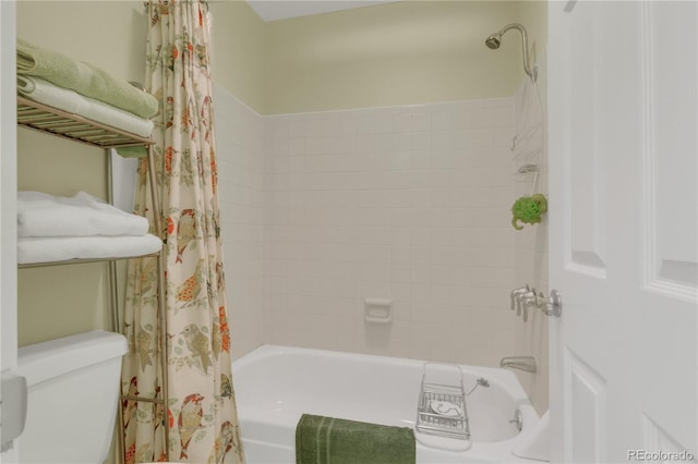 bathroom with shower / bath combination with curtain and toilet