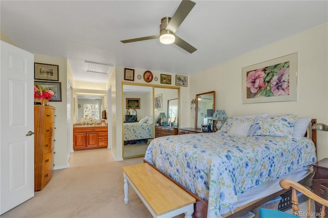 bedroom with light colored carpet, a closet, and ceiling fan