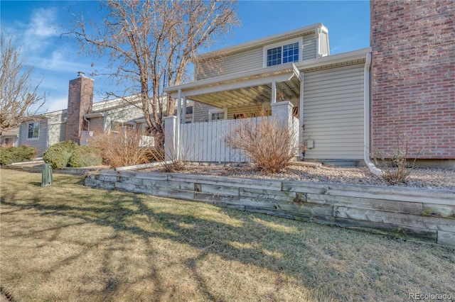 rear view of house with a lawn