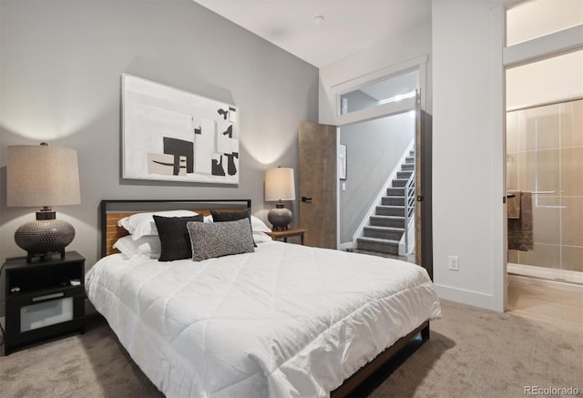 bedroom featuring ensuite bath and carpet floors