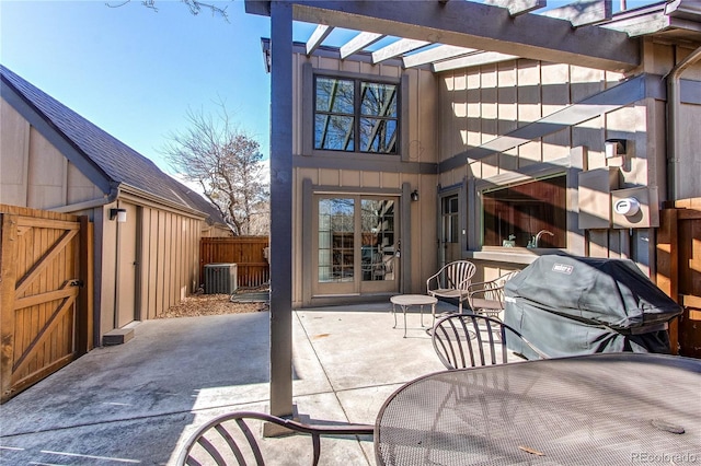 view of patio featuring a gate, central AC, fence, and area for grilling