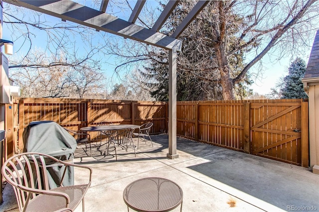 view of patio / terrace with outdoor dining space, a gate, and a fenced backyard